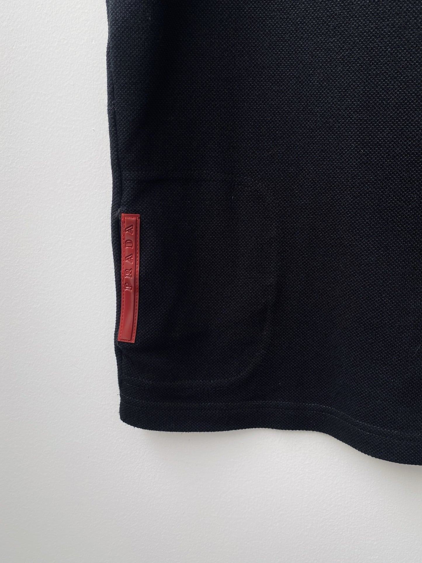 Prada — Sleeveless Polo Zip Top.